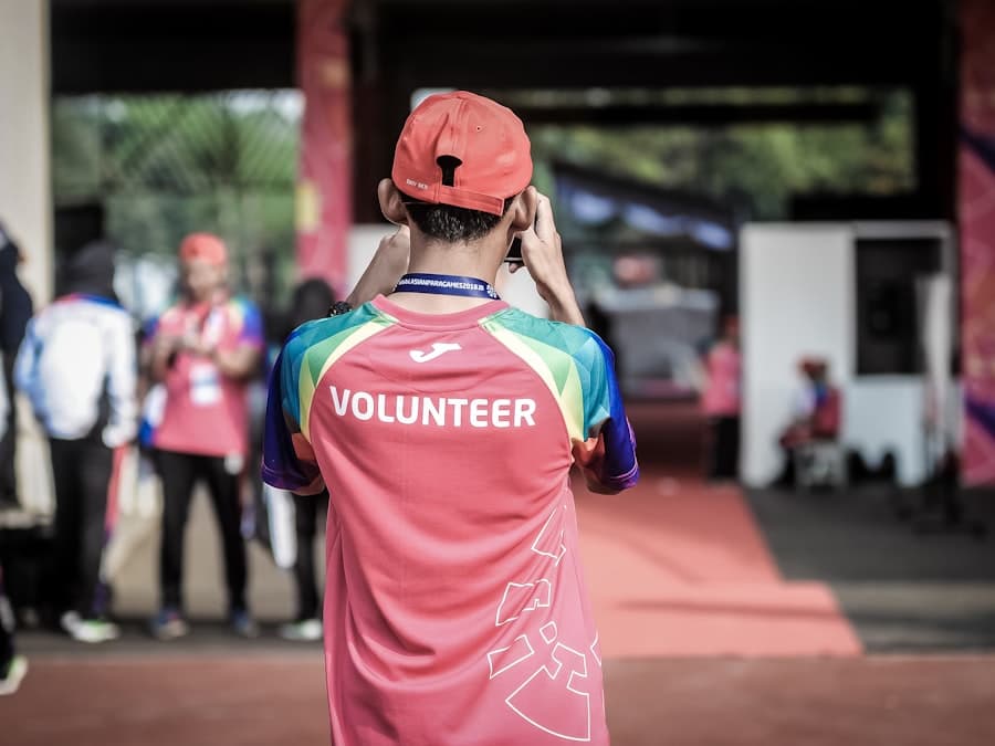 A smiling volunteer standing with her team